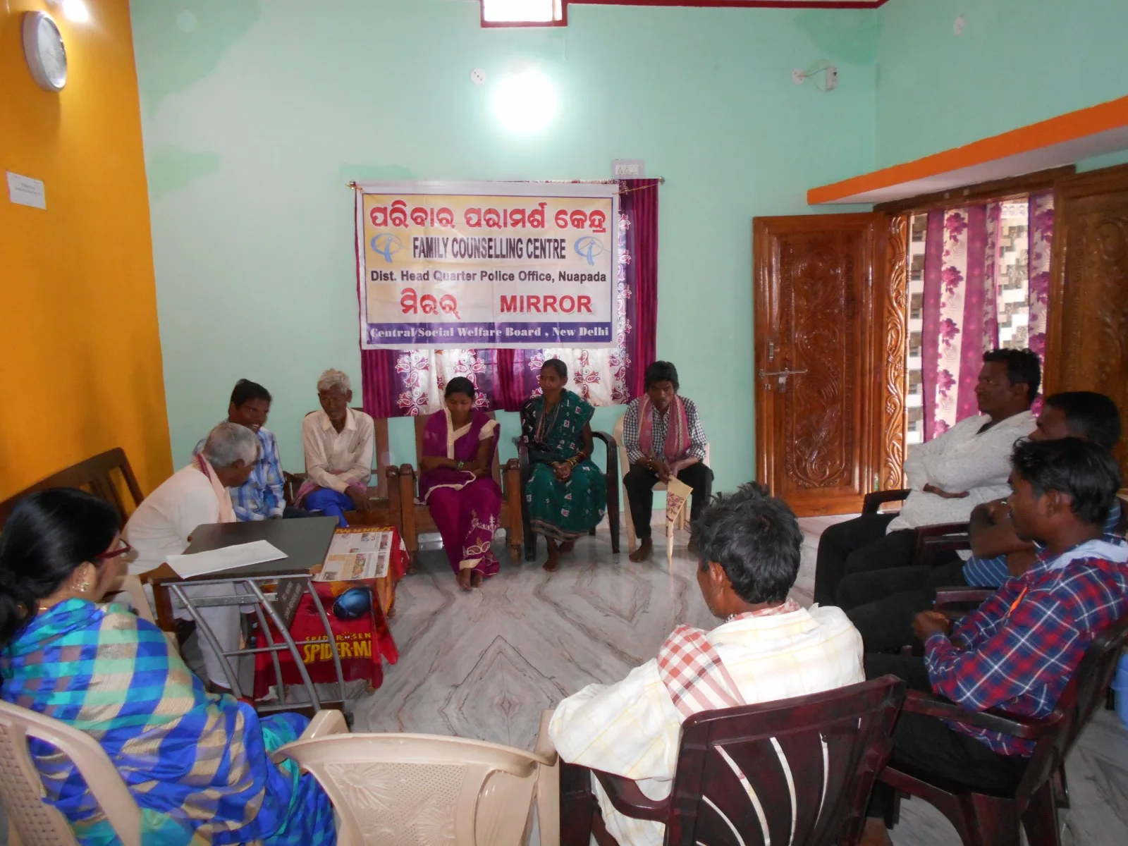 Adults seated in a circle during a Family Counselling Centre session